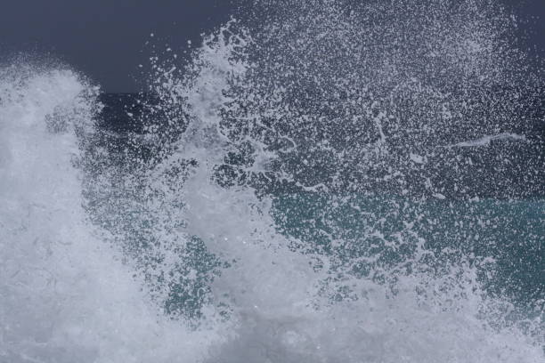 istock Wave crashing onto shore, sunny day and rough water 1277595219