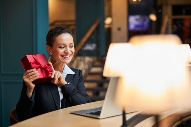 istock Pleased international female demonstrating her gift box 1277595420