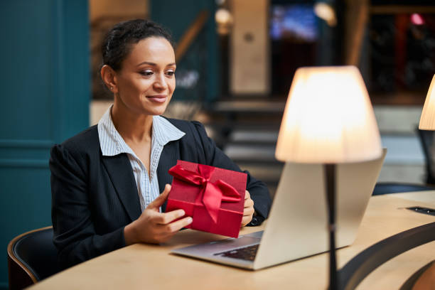istock Pleased young female person holding gift box 1277595426