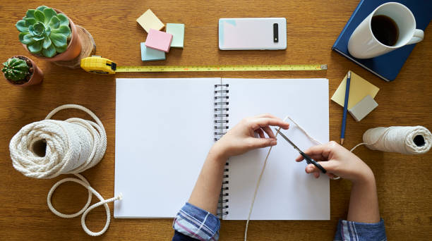 istock A young woman starting to work on macrame decor with tools over a creative desktop 1277597732