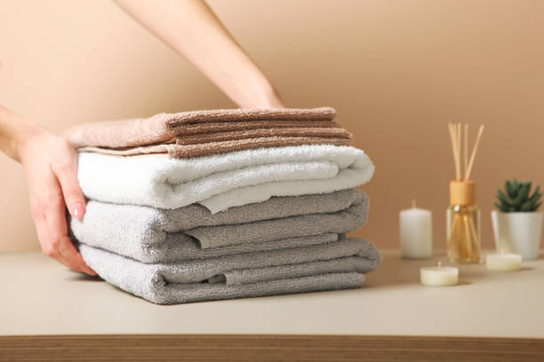 istock a stack of fresh towels in female hands. 1277598707