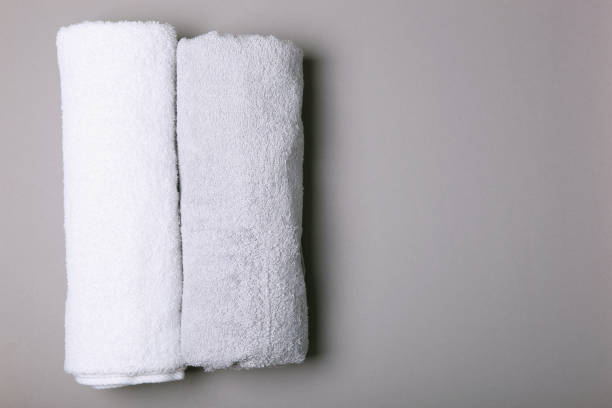 istock Fresh towels on a colored background with place for text top view. 1277598807