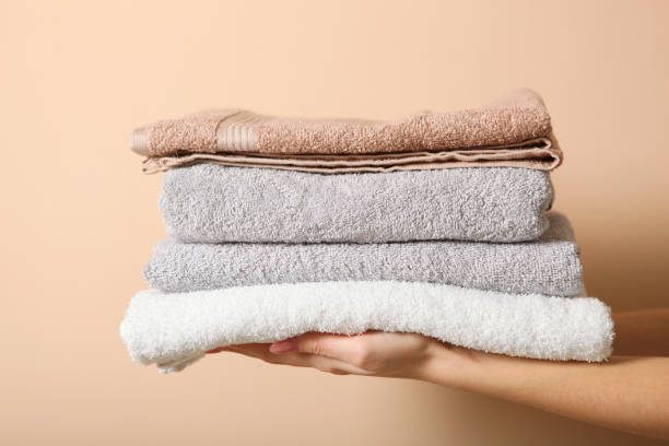istock a stack of fresh towels in female hands. 1277599057
