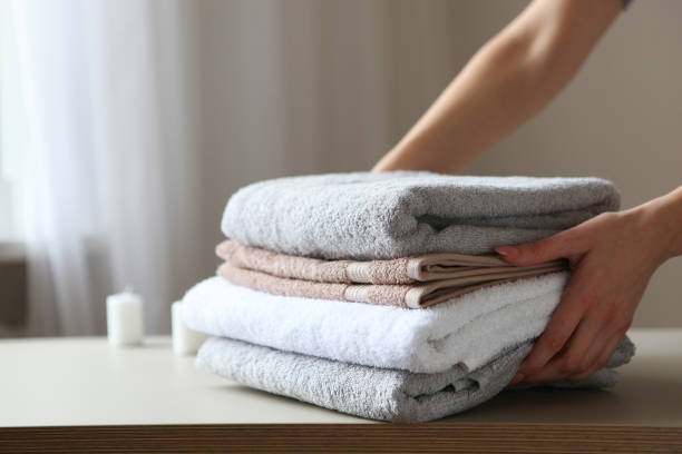 istock a stack of fresh towels in female hands. 1277599134