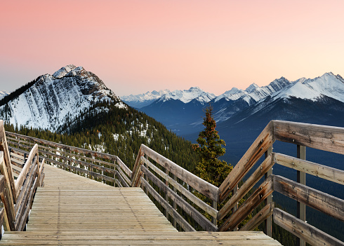 Spectacular sunset Canadian rocky mountains and boardwalk on Sulphur Mountain connect to Gondola landing in Banff, Canada. Gondola ride to Sulphur Moutain overlooks the Bow Valley and the town of Banff.