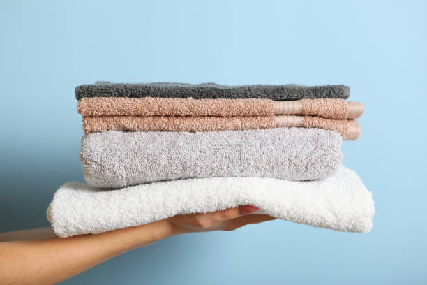 istock a stack of fresh towels in female hands. 1277599378