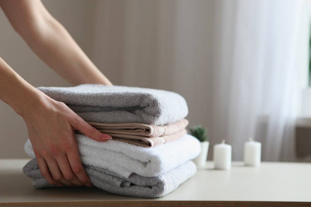 istock a stack of fresh towels in female hands. 1277599380
