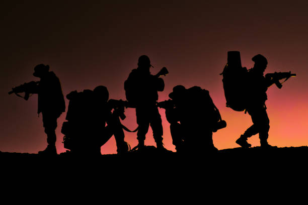 Silhouette of combatants against sky Silhouette of combatants against sky indian soldier stock pictures, royalty-free photos & images