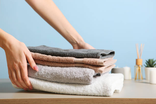 istock a stack of fresh towels in female hands. 1277600661