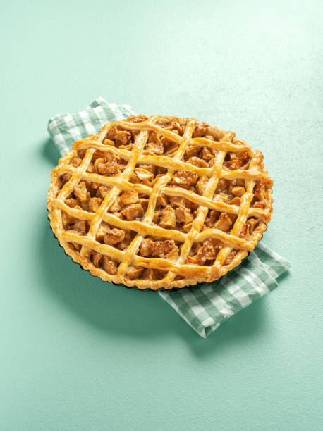 istock Apple pie minimalist on a green table. Homemade apple tart. 1277601407