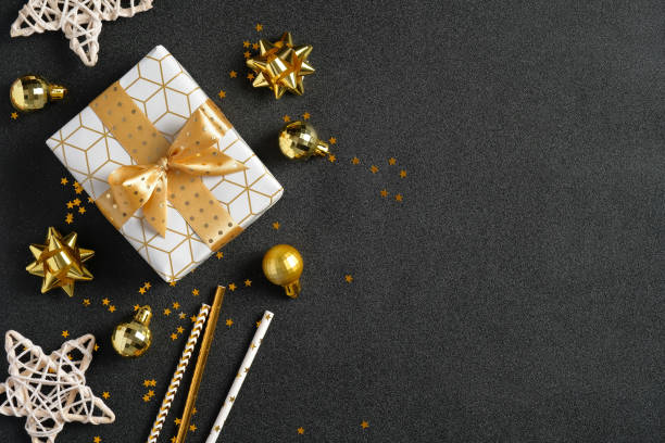 istock Dark Christmas background with luxury gift box, golden decorations, glitter confetti. Christmas, winter holidays, New Year concept. Flat lay, top view 1277604652