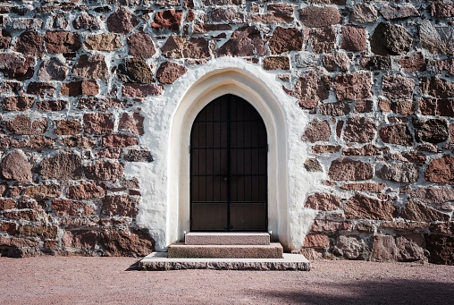 old wooden door under a stone arch old building in Äland, Västernorrland County, Sweden