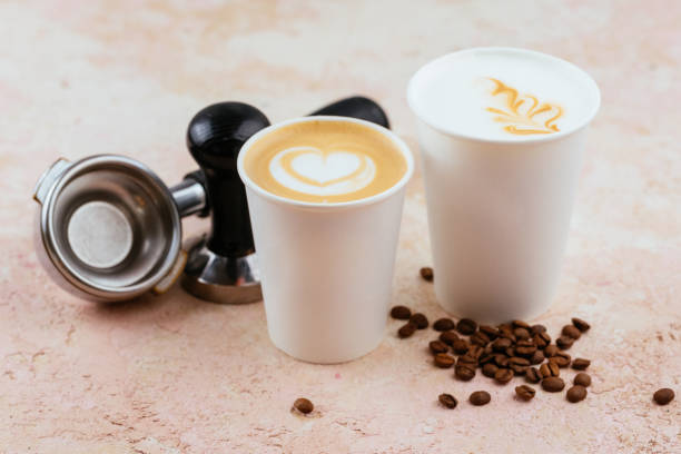cappuccino and latte in disposable paper cups on a light backgro