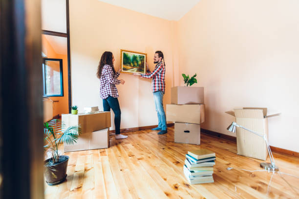 istock Excited couple hanging picture on wall 1277605564