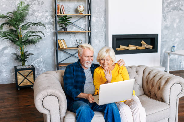istock Senior couple with a laptop indoors 1277605817