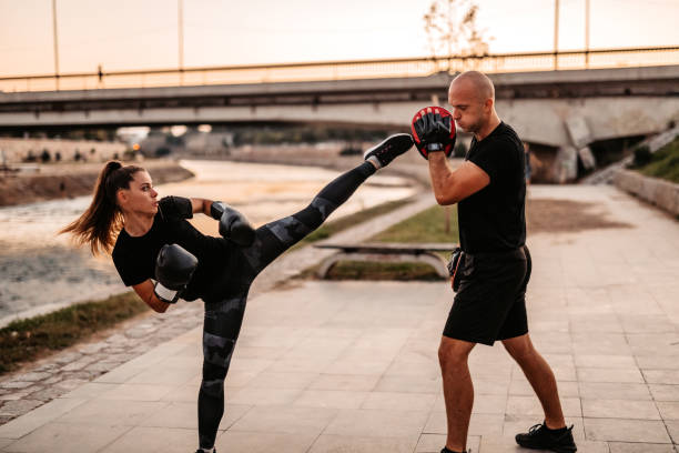 istock Man and a woman practice kick boxing 1277607596