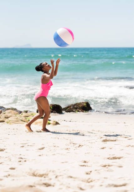 Shot of a little girl playing with ball on the beach