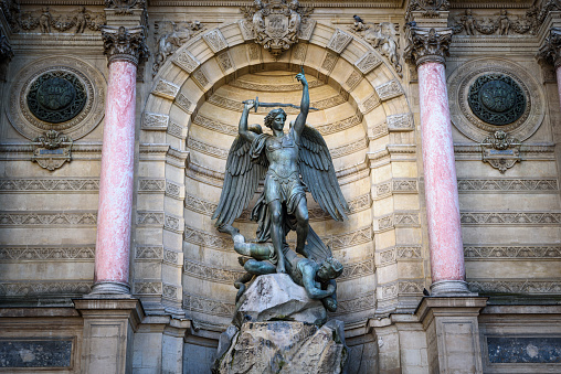Detail of the monumental fountain on Place Saint-Michel in Paris. This fountain, made in 1860 by Gabriel Davioud, shows the archangel St. Michael fighting the devil.