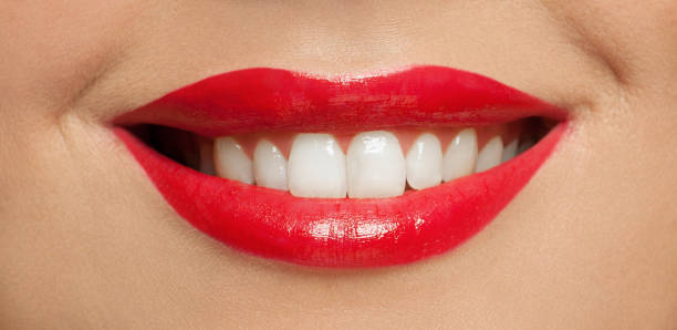istock Toothy smile with white teeth and red lipstick makeup 1277610415