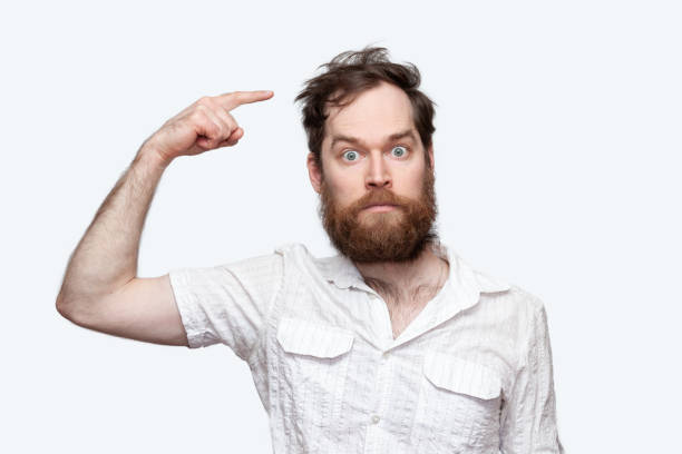 istock Bearded man pointing at his messy haircut over white background 1277610870
