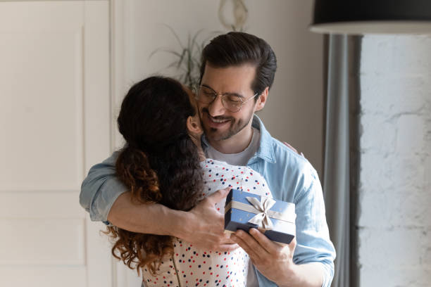 istock Happy man hug wife making birthday present 1277612594