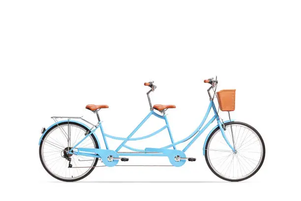 Photo of Studio shot of a blue tandem twin bicycle