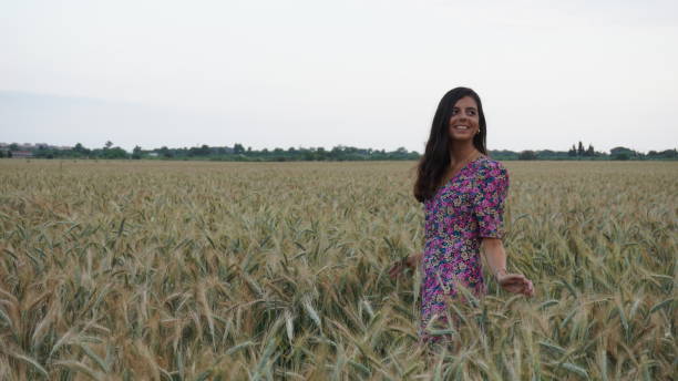 istock young woman smiling in a wheat field 1277613813