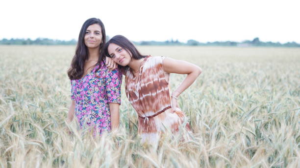 istock two young girls smiling in a wheat field 1277613976
