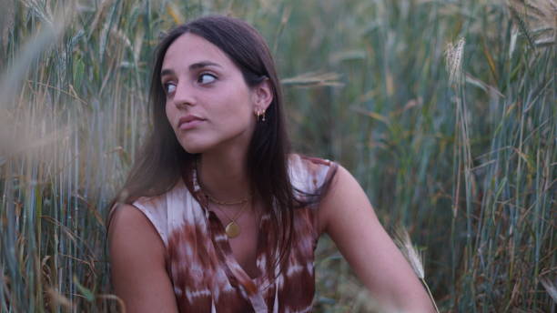 istock young girl sitting in a wheat field 1277614900