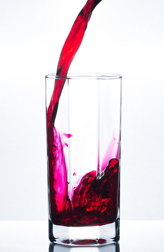 Red wine in a glass on a white background.