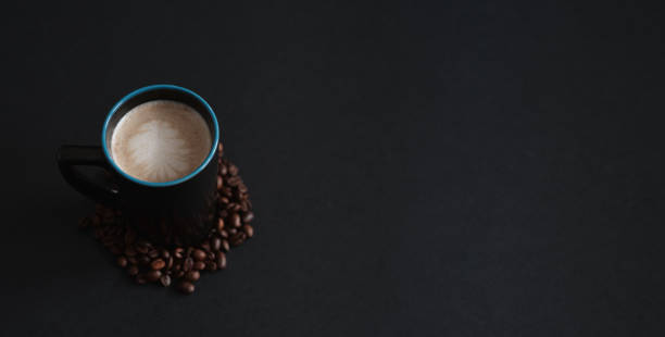 istock Dark cup of creamy coffee on a dark background with space for text 1277618185
