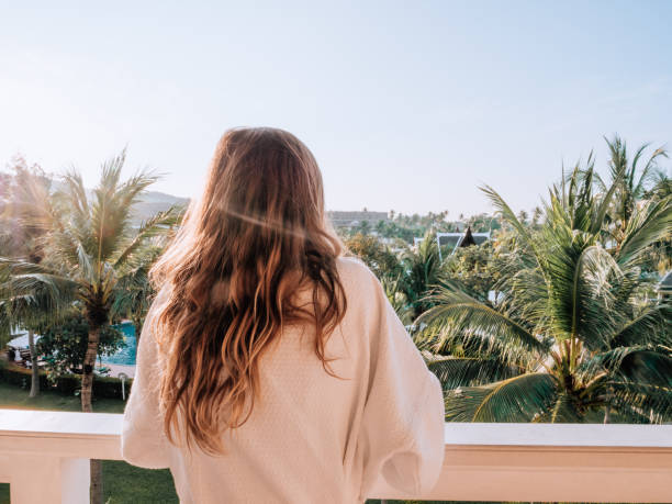 istock Woman watching sunrise from balcony 1277618533