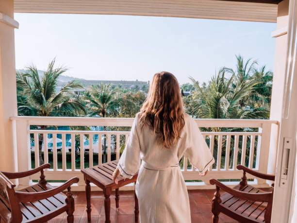 istock Woman watching sunrise from balcony 1277618618