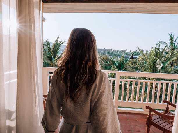 istock Woman watching sunrise from balcony 1277618619