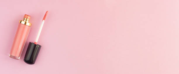istock Pink lip gloss on a pastel pink background. Flat style. Mockup for your design. Web banner. Copy space. 1277620411