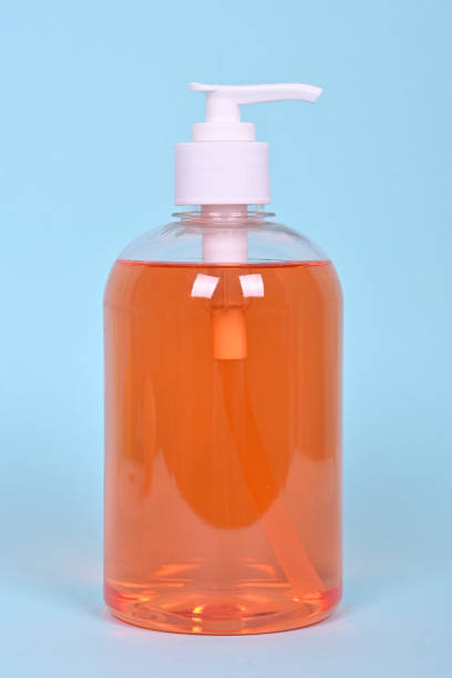 istock A bottle of orange liquid soap on a blue background. 1277622577