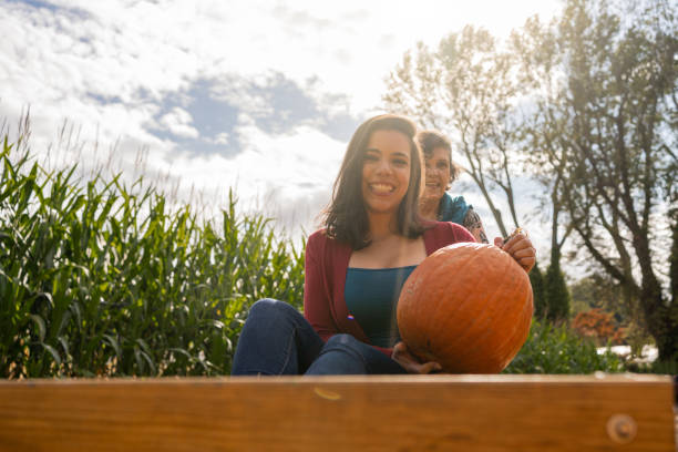 istock Daughter and mother playing during pumpkins picking 1277626641