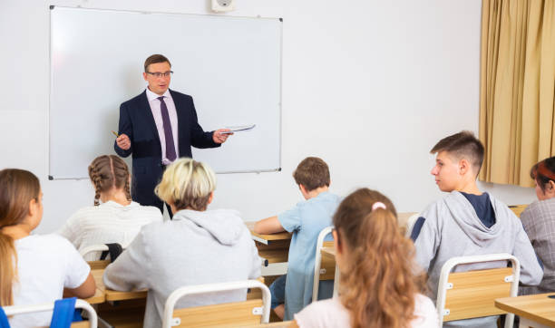 istock Adult teacher is giving lecture for students in class 1277627786