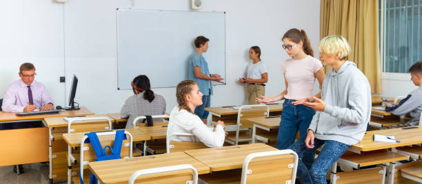istock Teen students communicating during recess in classroom 1277627806