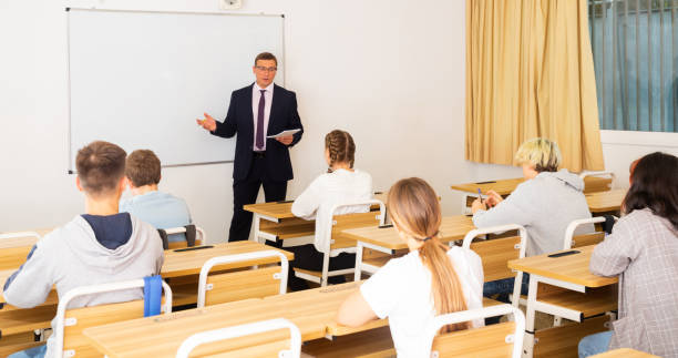 istock Adult teacher is giving lecture for students in class 1277627808