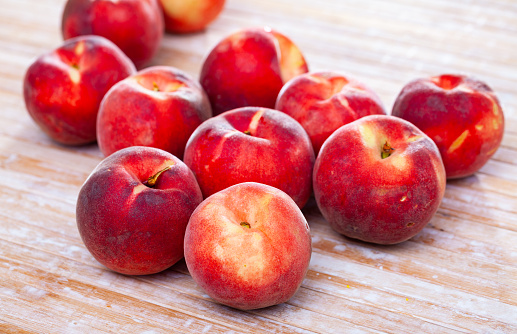 Group of fresh sweet peaches on wooden table