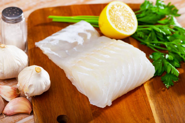 istock Uncooked rose eel fillet fish with parsley and garlic on table 1277628620