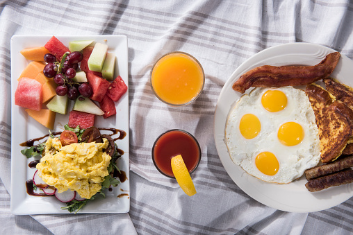 Sandwich egg with fruit salad VS Sunny side up egg with sausage, bacon and French toast (Click for more)