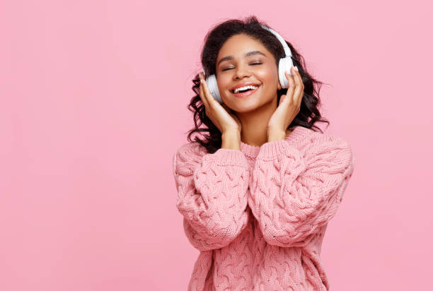 istock Delighted ethnic woman enjoying music 1277636242