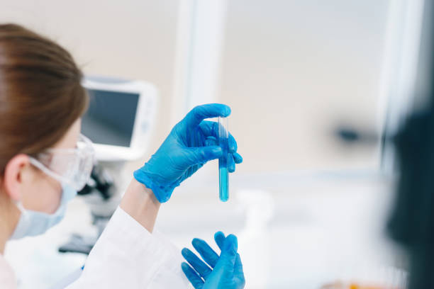 istock close up. laboratory workers with test tubes sitting at the laboratory table 1277637969