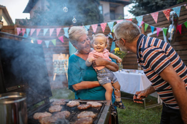 istock Grandfather grilling meat for a barbecue party 1277638412