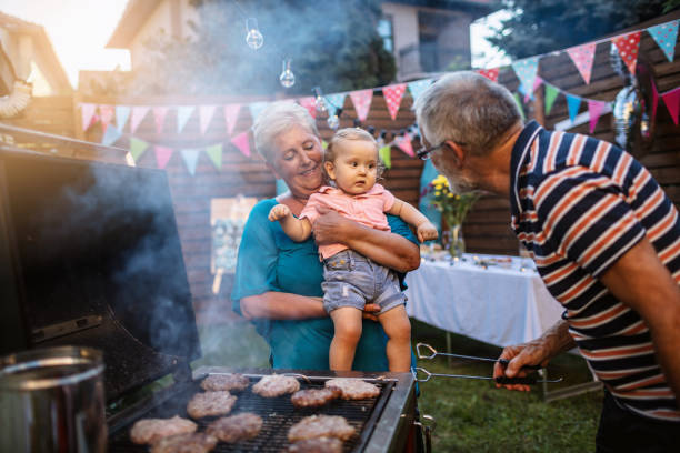 istock Grandfather grilling meat for a barbecue party 1277638510