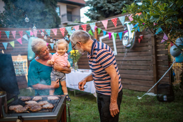 istock Grandfather grilling meat for a barbecue party 1277638576