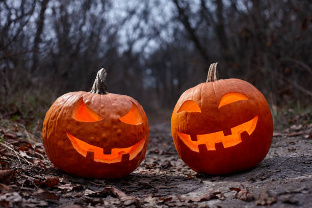 istock Halloween pumpkins burning in forest at night 1277638736