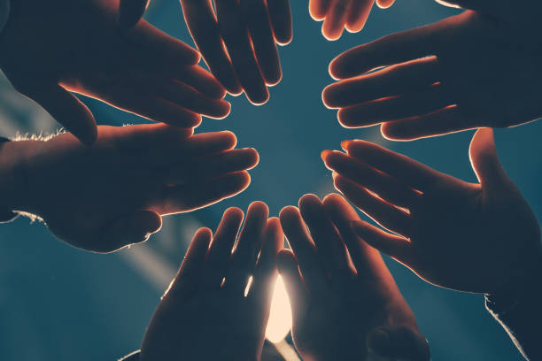 istock close up. young business people joining their palms in a circle 1277642316